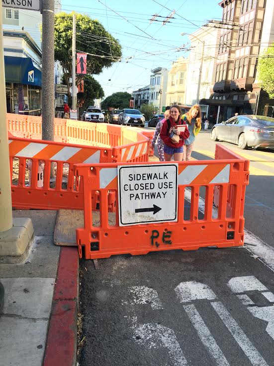 Convent Elementary students  maneuver around the closed sidewalk on their way to school this morning. The sidewalk closed last week and will remain closed until construction is finished.  