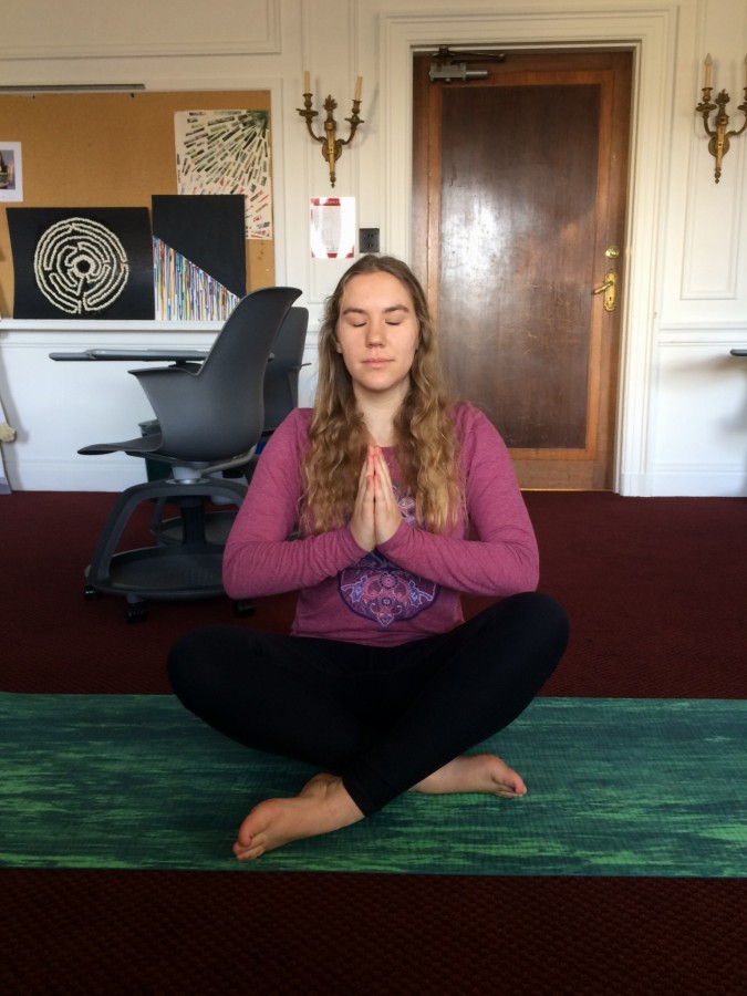  Senior Clara Phipps practices yoga in her theology class as a break from their lessons on ecojustice and catholic social teachings.  The senior theology classes are finishing up the year with group ecojustice presentations on topics of their choice including topics such as keystone species, fracking and pollution. 