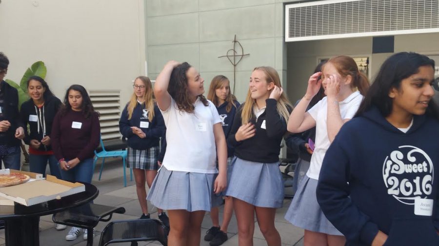 Incoming freshmen joke with each other in the Stuart Hall High School courtyard. Both schools student councils organized icebreakers such as jukebox where students were separated into four different groups and had to think of different songs with a key word in common without repeating the the previous ones sung.