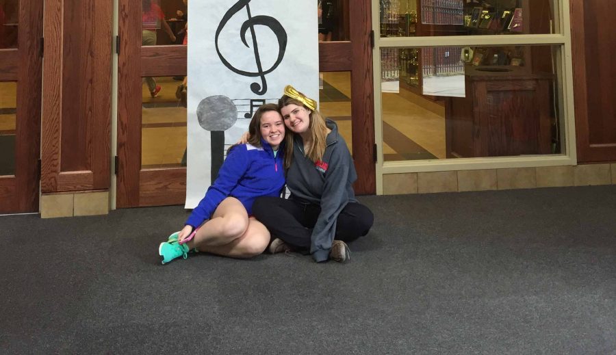 Sophomore Katie Walsh and senior Grace Neary from the Duchesne Academy of the Sacred Heart in Omaha, Nebraska announce Congé. The student body engaged in a musically-themed holiday.