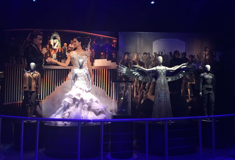 Katniss+Everdeen+is+highlighted+through+a+series+of+costumes+in+the+final+room+of+The+Hunger+Games%3A+The+Exhibition.+Six+exhibit+rooms+showcase+some+of+her+most+popular+outfits.