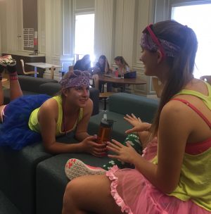 Seniors Katie Newbold and Delaney Moslander wear coordinating outfits for todays color day. The two handed out colorful bead necklaces to less eager participants.