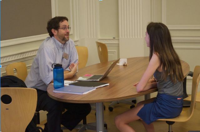 English teacher Mark Botti spends World Teachers’ Day in the Center talking to freshman Isabella Parmenter. Botti stated that he finds time to teach students even when not in the classroom.