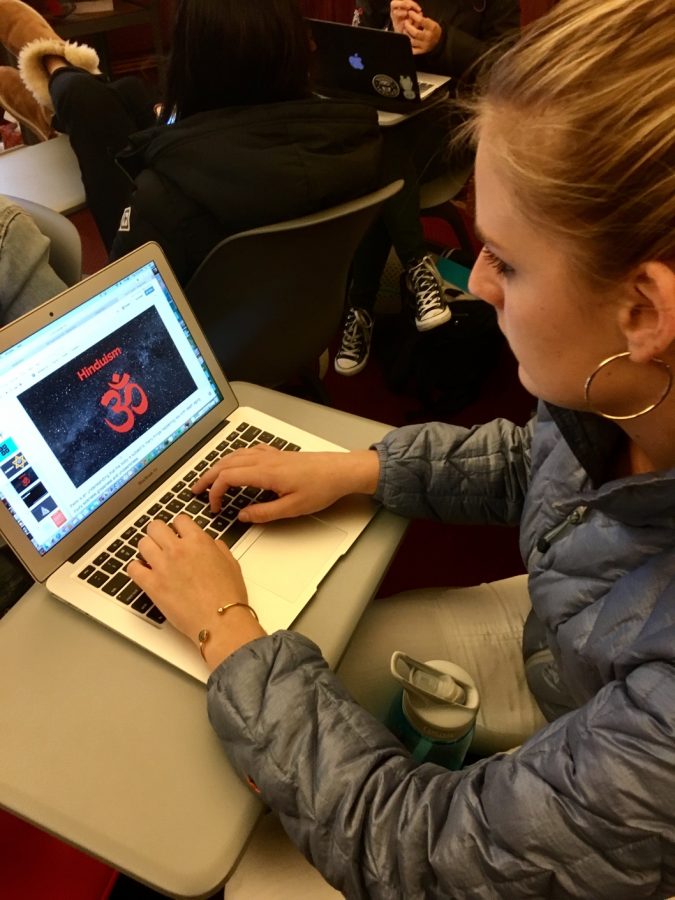 Sophomore Grace Boudreau reviews theology slides before her final presentation in class. Students were asked to give eight to ten minute summaries of an assigned passage, including any and all connections made to them.