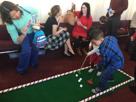 Kids play miniature golf during the annual Deck the Halls event, featuring activities for attendees.