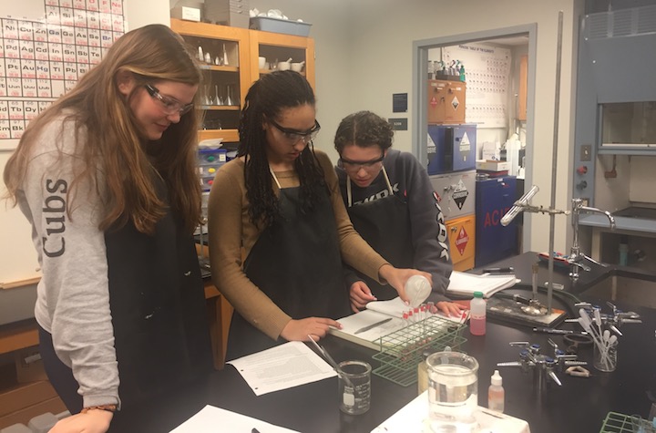 Seniors Dot Wetmore, Gia Monachino and Ana Cahaus work on an AP Chemistry lab that was postponed until today because of Siboni’s closure. The chemistry class, along with most math and science classes, was relocated to Stuart Hall.