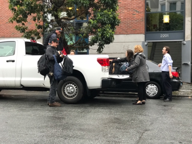 Maintenance and faculty load students belongings into the school truck. As fire alarm blared students  evacuated the building unable to bring their bags.