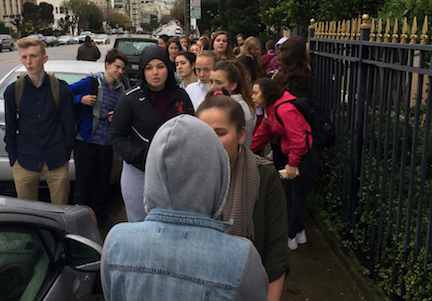 Students stand outside the Italian Consulate after evacuating the campus. Fire alarms first rang from the Siboni building after an incident in the physics lab.