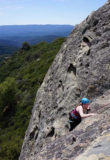 Club head Claire Kosewic tops out on a climb last year at Castle Rock State Park in Santa Cruz, California. Kosewick has been climbing for over a year now.