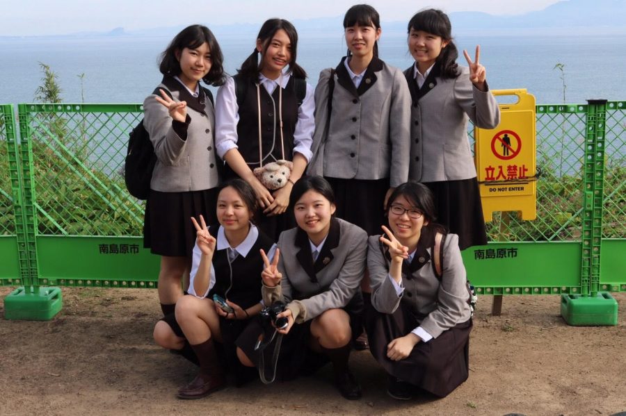 High school third graders, the equivalent of a high school senior in the United States, from Sapporo Sacred Heart School in Japan pose in their winter school uniforms. The uniform varies seasonally, with a brown checked skirt and blouse in summer, and the same skirt with a sweater and hooded jacket and winter.