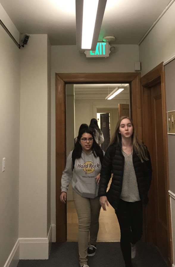 Two freshmen walk in front of the security camera in the second floor hallway. There are two other security cameras in the Main Hall and in the staircases.