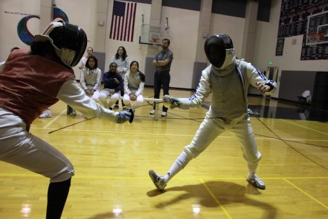 Fencing team captain April Matsumoto thrusts her foil at an opponent. Matsumoto is preparing the team for the San Francisco AAA/ CIF High School All-City Championship. 