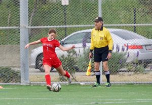 Senior captain Delaney Moslander takes a kick after a foul was called against College Prep during a game in Berkeley on March 23. The game was not a league game and did not contribute to the team’s path to playoffs. 