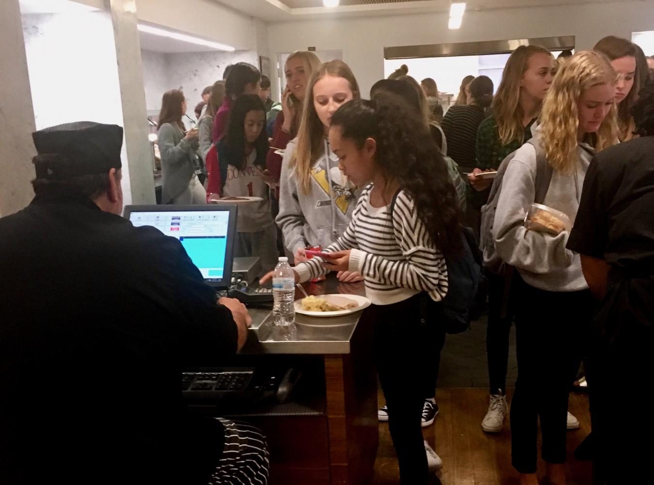 Students wait to pay for lunch as freshmen Aliza Manayan and Hallie Williams enter their pins one at a time. New registers and keypads were introduced along with Sage Dining service this fall.