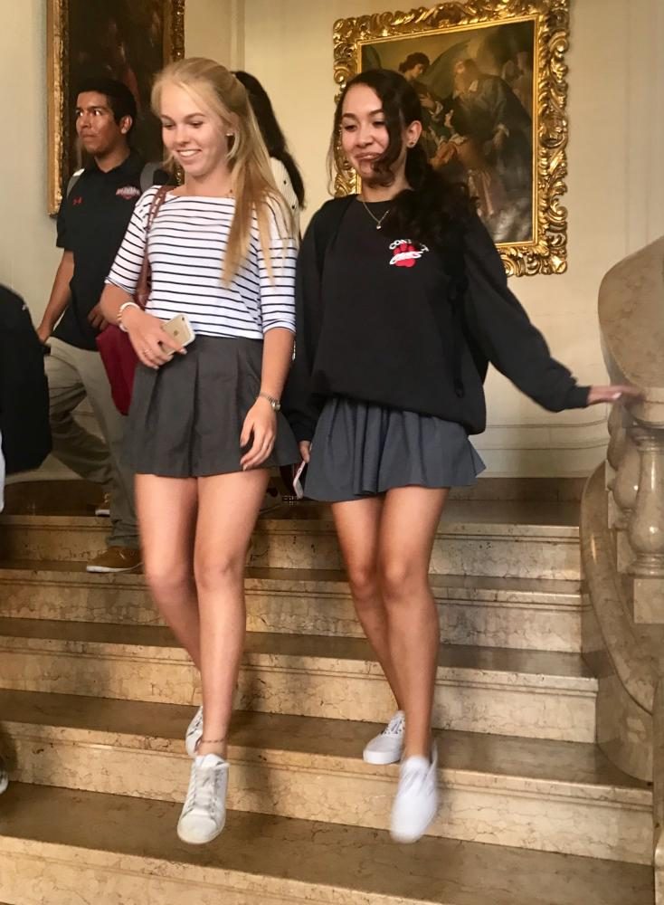 Sophomores Phoebe Froeb and Sunny Stuart leaving class at dismissal. Students wore the uniform skirt without tights today due to the heat wave.