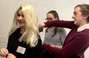 Math teacher Amy Leaver trims junior Olivia Mohun’s blonde wig to complete Mohun’s Student-Teacher Swap look. Today was the first of the five day Spirit Week, with Decade, Pajama, Jersey and Convent & Stuart Hall Spirit Days as the themes throughout the rest of the week.