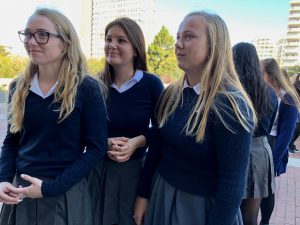 Seniors Annie Macken, Rosie Morford and Caroline OConnell wait outside Saint Mary of the Assumption before the senior procession into the cathedral. The senior procession starts the Mass of the Holy Spirit along with the opening prayer.