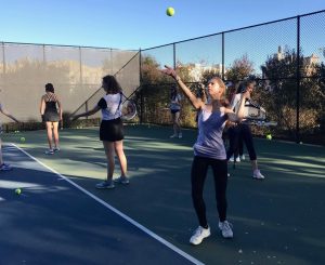 Sophomore Zoe Hinks serves during a JV tennis practice at Lafayette Park. The JV team has only two more practices up until the JV Jamboree, which will conclude their season.
