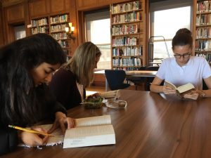 Sophomores Alisha Kalra, Brooke Wilson and Arlena Jackson read in the Mother Williams Library during a book club meeting. The club meets every other Wednesday during lunch. 