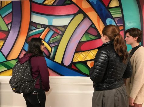 Sophomore Lauren Tulley explains the color choices of the mural to sophomores Cat Webb-Purkis and Sophia Aeby. Tulley worked with two other students to help to coordinate the mural and it’s location.