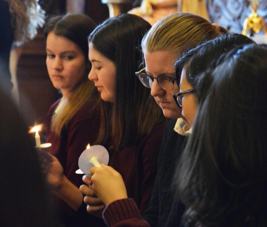 New inductees Olivia Mohun, Josephine Rozzelle, Lizzie Bruce and Angela Chao light their candles, signifying their NHS membership. NHS members shared inductees' achievements through short speeches.