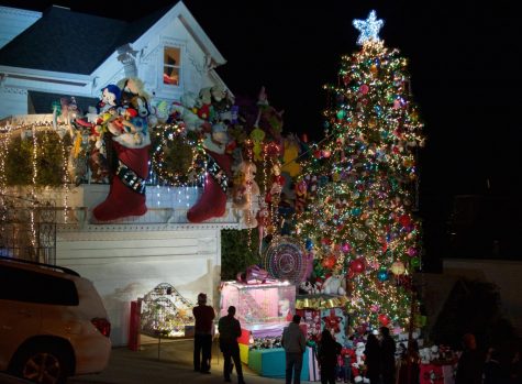 Crowds gather outside the home of Tom Taylor and Jerry Goldstein to see the grand Christmas display and visit Santa Claus. The couple hires Santa each night from 6:30-10:00 p.m. throughout December 24 to hand out candy canes and take photos.  
