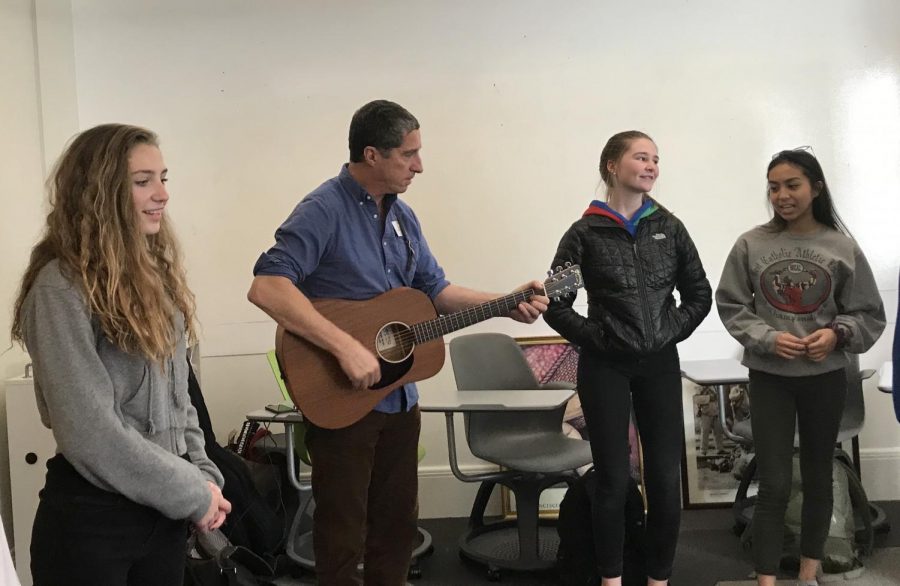 French and Spanish teacher Pascal Parra practices a song with his students from his French II class. The French classes picked a new song this year.