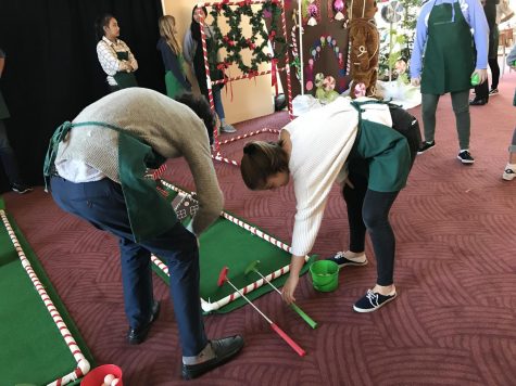 Sophomores Sofia Telfer and Henry Sears set up a game of miniature golf prior to the arrival of children at ‘Deck the Hall’. ‘Deck the Hall’ is an annual event hosted by Davies Symphony Hall, which includes games, photos with Santa and a concert.