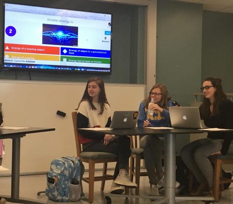 Juniors Emma Kob, Molly Brown, and Amelia Estes participate in a Kahoot quiz before their physics class. The Kahoot reviewed topics they had gone over earlier in the semester as a refresher.