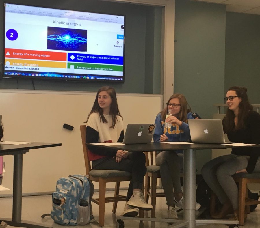 Juniors Emma Kob, Molly Brown, and Amelia Estes participate in a Kahoot quiz before their physics class. The Kahoot reviewed topics they had gone over earlier in the semester as a refresher.