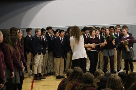 Spanish teacher Mary Bicanic leads the high school Spanish classes in singing "El Burrito Sabanero"  while juniors Darrean Loy, Kiki Apple and Delaney Tobin play the instruments. The majority of the high school students take Spanish as a foreign language class.