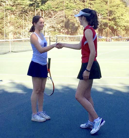 Team co-captain Josephine Rozzelle shakes hands with her opponent from the Urban School. Before each match, the captains from both teams announce each player who shakes the opposing teams hands as well as the hands of both coaches.
