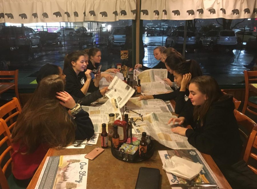 The Cubs decide what to order at Black Bear Diner after their first game. They piled their phones in the middle of the table after ordering to have a tech-free dinner. 