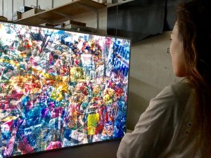 Day El-Wattar views one of Jim Campbell’s pieces made from photos at the 2017 Washington D.C. Women’s March. The work is made up fluorescent lights shining through a layer of 12 different photos from the event.