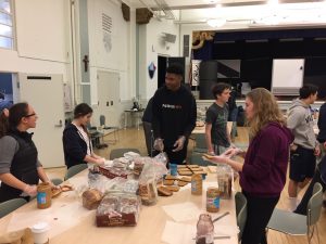 Freshmen Sarah El-Qadah, Gabrielle Gudio, Nigel
Burris and Amy Phipps prepare sandwiches in the Columbus Room
at Stuart Hall. One Less Hungry meets to pack lunches on Sundays
once a month.