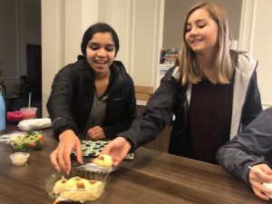 Sophomores Avani Mankani  and Brooke Wilson eat hamentashens in the center during lunch to celebrate the Jewish holiday Purim. Hamentashens are traditional triangle shaped cookies eaten primarily during Purim.