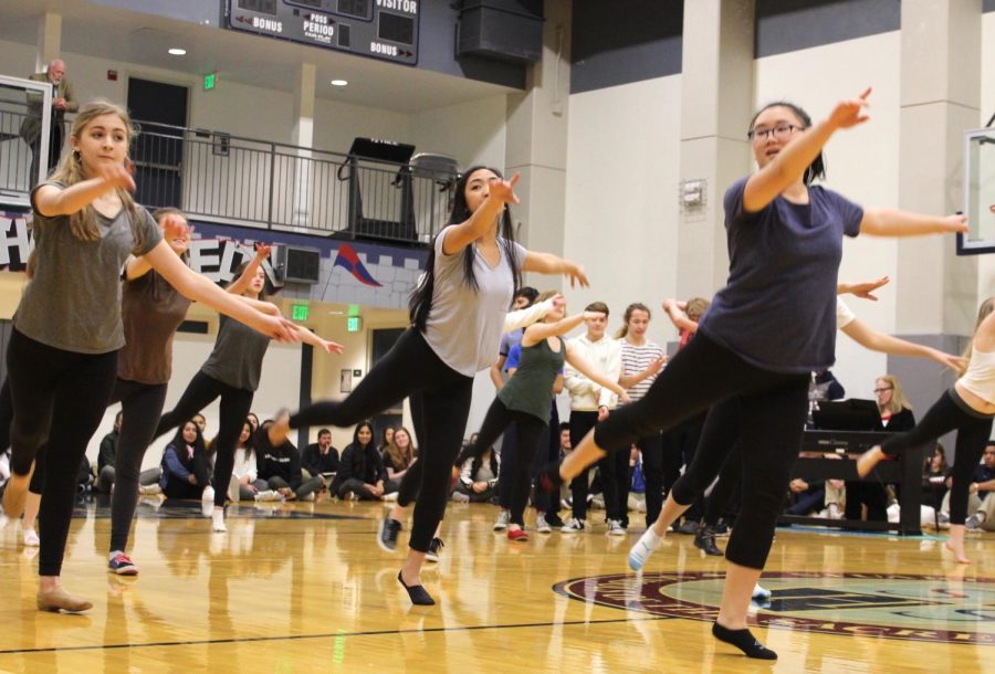 Freshman Grace Krumplitsch and juniors Bianca Mercado and Tommie Akamine perform the opening dance of A Chorus Line during the Convent & Stuart Hall pep rally last week. The cast and crew have been rehearsing the musical since December.