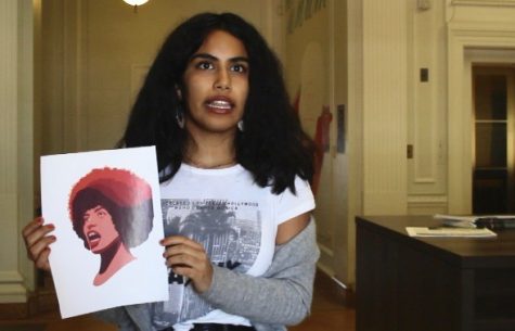 Sophomore Malinalli Cervantes explains her artwork during an interview. The women in the piece is based off of Angela Davis, and is meant to be a representation of strong women.