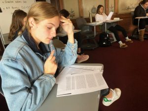 Junior Maggie Walter reviews an example passage from a past AP English Language and Composition exam. Walter will take the exam on Wednesday, May 16 with the rest of the IB and Honors English III Convent & Stuart Hall students.