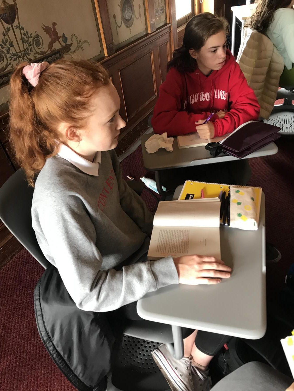 Zoe Forbes and Zoe Hinks model proper dress code attire, while taking part in an International Baccalaureate higher level junior English class discussion. The revised dress code does not allow white jeans.