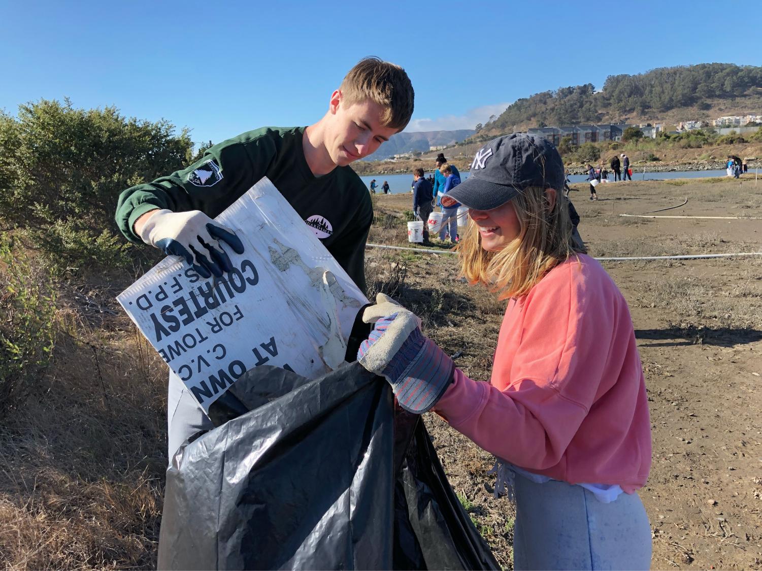 Seniors Rachel Cramer and Nick Harle pick up trash from the beach at the annual California Costal Cleanup. This year's cleanup fell on the Sacred Heart annual Global Service Day.