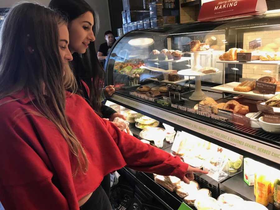 ORDER UP Freshmen Paige Retajczyk and Nina Guttierez wait in line to order at Starbucks. The Fillmore Street Starbucks is a popular lunch spot among Convent students. 
