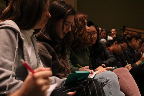 Seniors write notes of encouragement to a friend in need during a BC2M assembly. The club had students either keep the notes or give them to the friend.