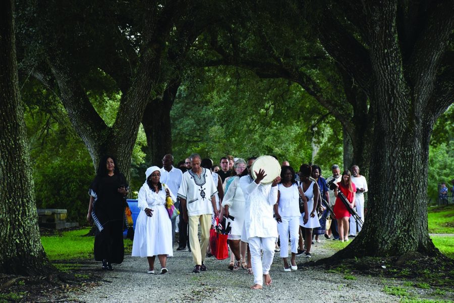 Descendants of people enslaved by the Society of the Sacred Heart after coming to
North America walk with friends and family from St. Charles Borromeo Church in Grand Coteau, Louisiana
to a nearby cemetery where a new monument honoring those enslaved stands. Brother Frank Authello
Andrus, Jr. led the procession with drumming