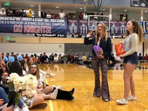 Sophomore and freshman class representatives Tabitha Parent and Mackenna Moslander throw candy to students during the co-ed Halloween costume contest. The Convent & Stuart Hall student council led the assembly at the Pine/Octavia campus. 