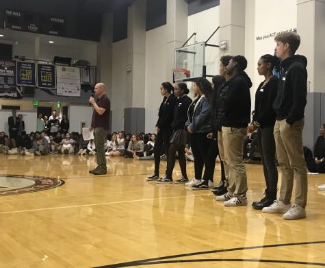 Members of POCSU line up in the Stuart Hall gym to present personal stories. Guest speaker Ted Saltveit mediated the conversation and asked students questions about their experiences with race.