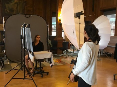 Senior Megan Mullins listens to the photographer instructing her how to pose for her senior yearbook portrait in the Mother Williams Library. The photos were moved to the library due to the Christmas trees set up in Belvedere where the photos originally were going to take place. 