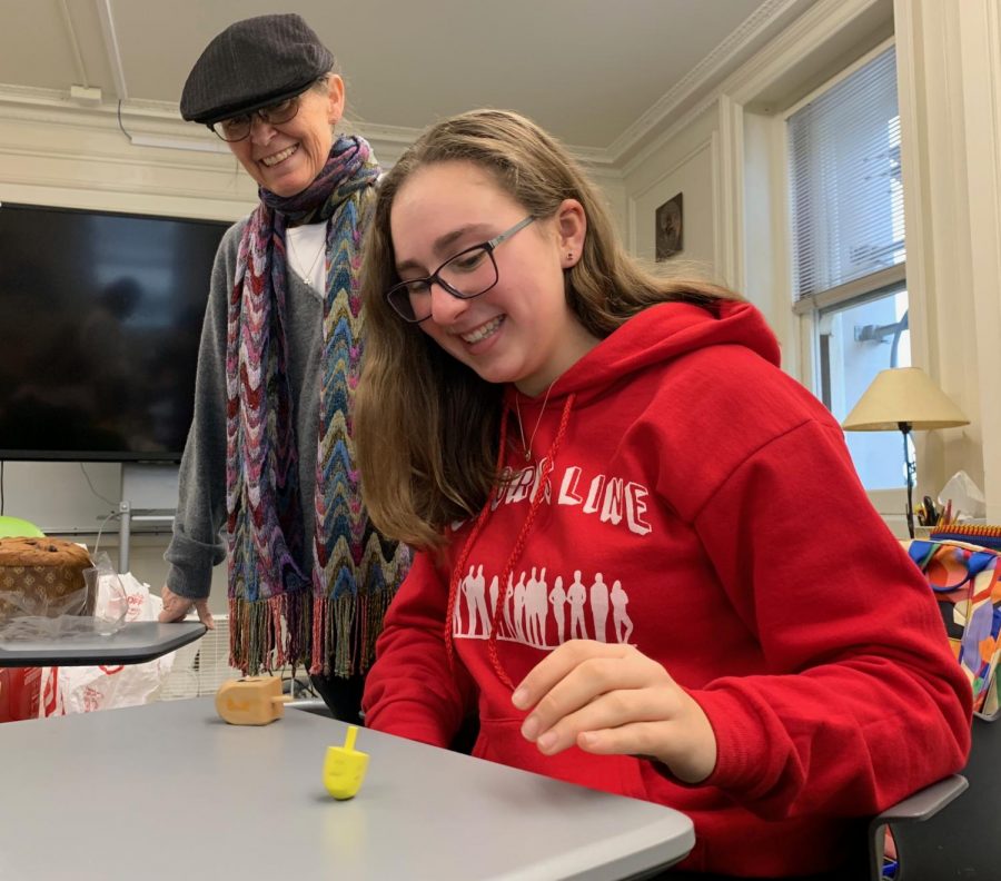 Sophomore Lili Levy plays with a dreidel during the Interfaith club’s Hanukkah celebration. In addition to Hanukkah, the club has honored other religious traditions and holidays.
