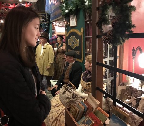 FESTIVITIES Sophomore Halsey Williamson looks into a bookshop
window at The Great Dickens Christmas Fair. The fair has dozens of
antique and gift shops to visit.