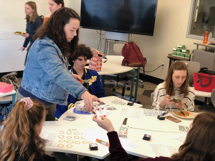 Card Club co-leader Dena Silver teaches members about Texas Hold’em Poker. First time poker player freshman Natalie Kushner aced the first round with a straight flush.